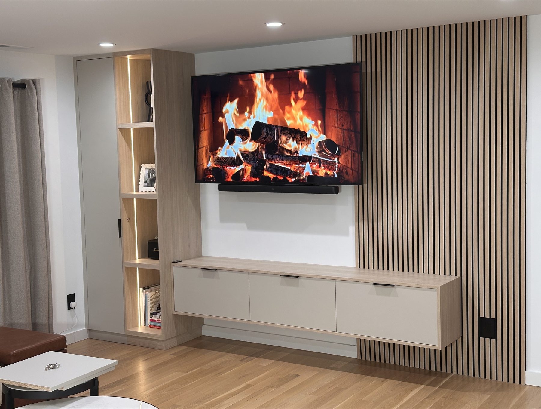 Custom TV wall with floating cabinet and slat panel feature