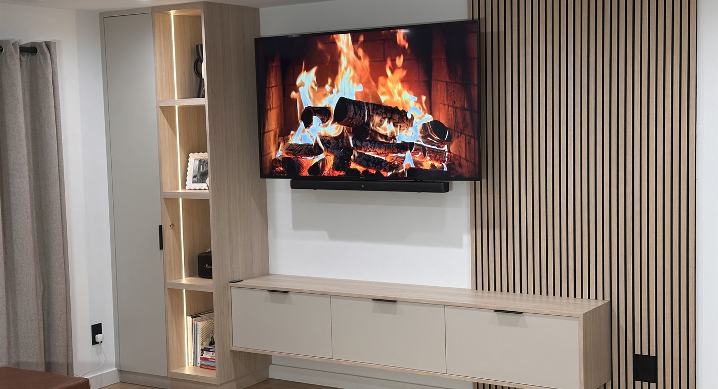Custom TV wall with floating cabinet and slat panel feature